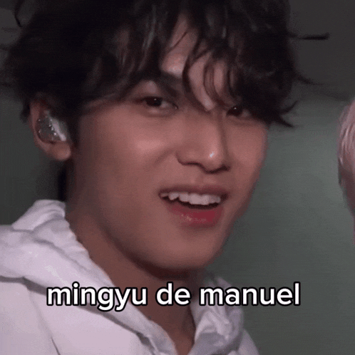 a close up of a person 's face with the caption mingyu de manuel on it