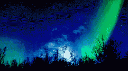 the aurora borealis is glowing brightly in the night sky