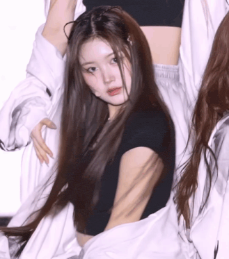 a woman with long hair wearing a black shirt