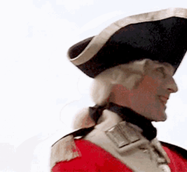 a man in a red uniform and a black hat is smiling