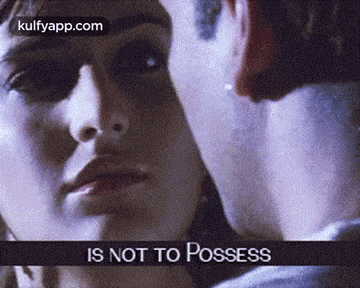 a close up of a man and woman kissing with the words `` is not to possess '' written above them .