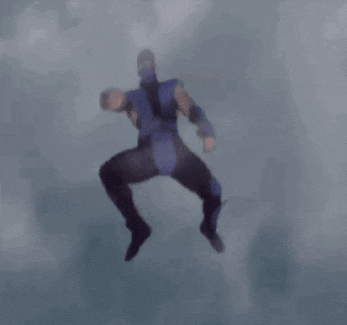 a man in a ninja costume is jumping in the air .