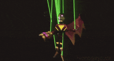 a video game character is being lit up by a spotlight with a city behind him