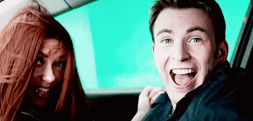 a man and a woman are sitting in the back seat of a car .