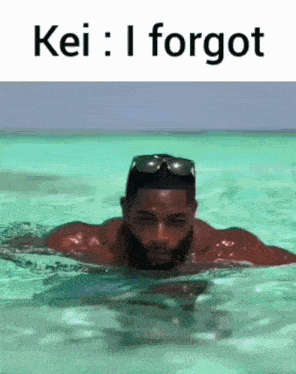 a man is swimming in the ocean with the words kei : i forgot above him