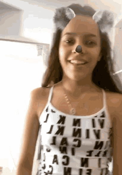 a girl wearing a tank top with the letters a and i on it