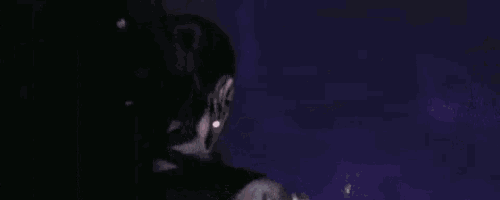 a person is looking at a purple and white painting .