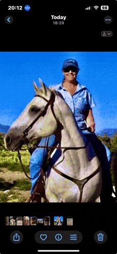 a picture of a woman riding a horse is displayed on a phone screen