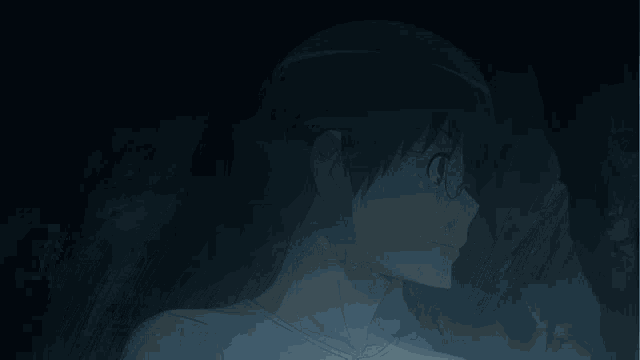 a person with glowing eyes covering their face in the dark