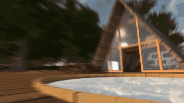 a blurred image of a house with a jacuzzi in front of it
