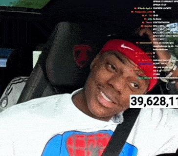 a man wearing a red nike headband is sitting in a car with the number 39,628,11 on the side