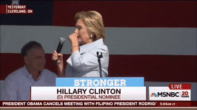 a woman stands at a podium with the words stronger on it