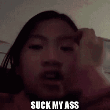 a young girl is making a funny face and says `` suck my ass '' .