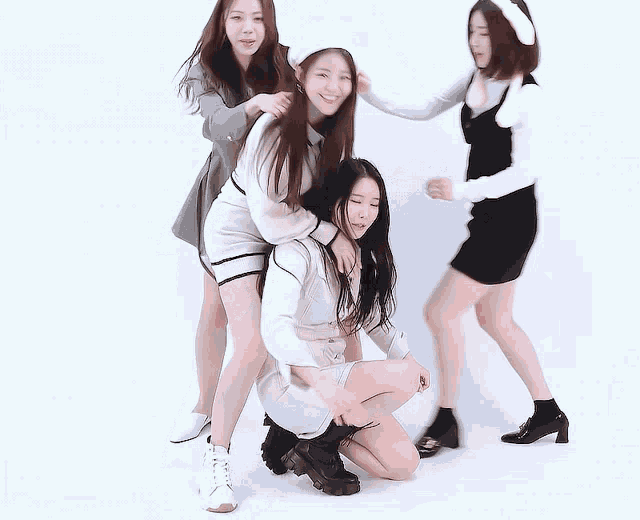 a group of girls are posing for a picture and one of them is wearing bunny ears