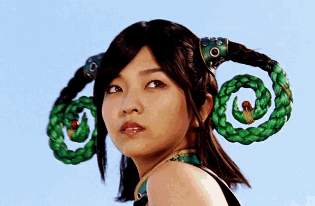 a woman with a green swirl in her hair and a blue sky in the background