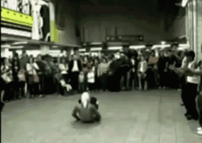 a blurry picture of a group of people dancing in front of a crowd .