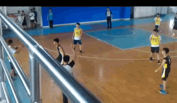 a group of young boys are playing basketball on a court and one of the boys has the number 43 on his shirt