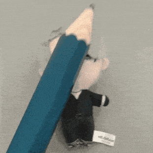 a blue pencil is being used to write on a stuffed toy