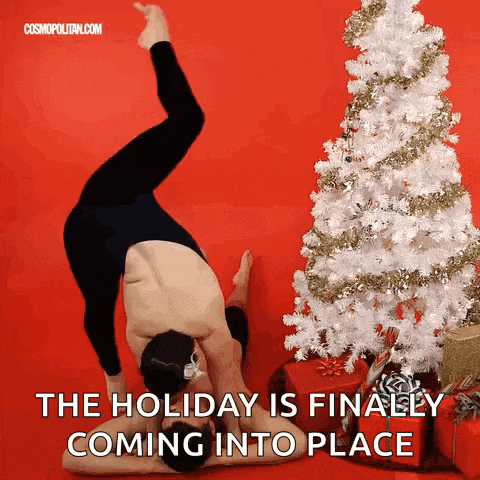 a man is doing a handstand in front of a white christmas tree with the caption " the holiday is finally coming into place "