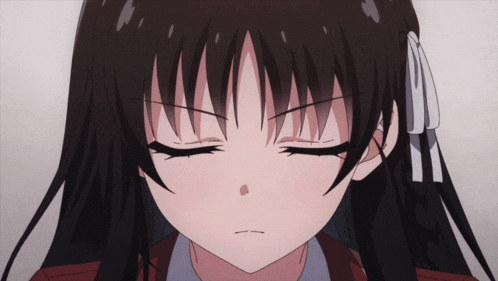 a close up of a girl with her eyes closed and a bow in her hair