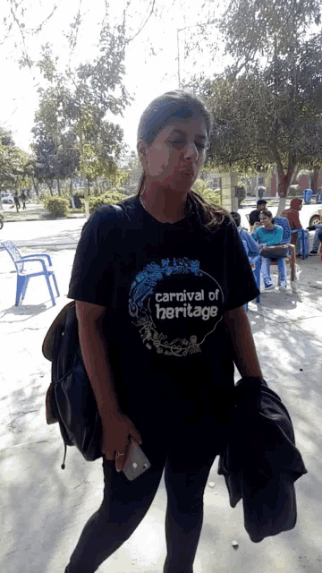 a woman wearing a carnival of heritage t-shirt