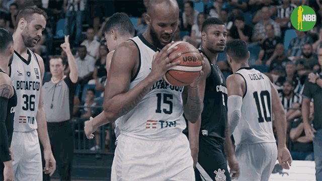 a basketball player with the number 15 on his jersey holds the ball