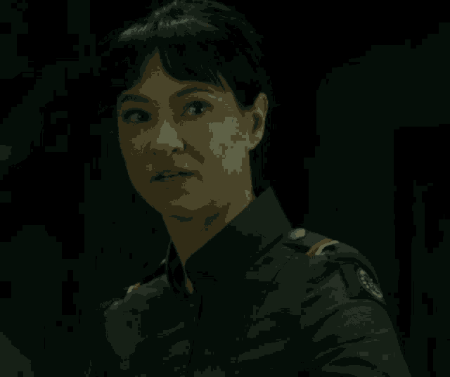 a woman in a military uniform has a badge on her chest