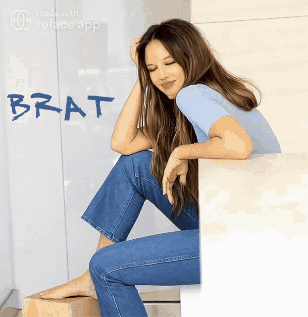 a woman is sitting on a ledge with the word brat written on the wall behind her