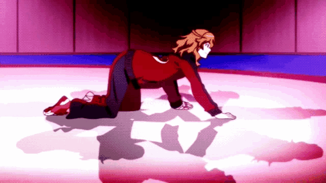 a woman in a red shirt is kneeling down on a ice rink