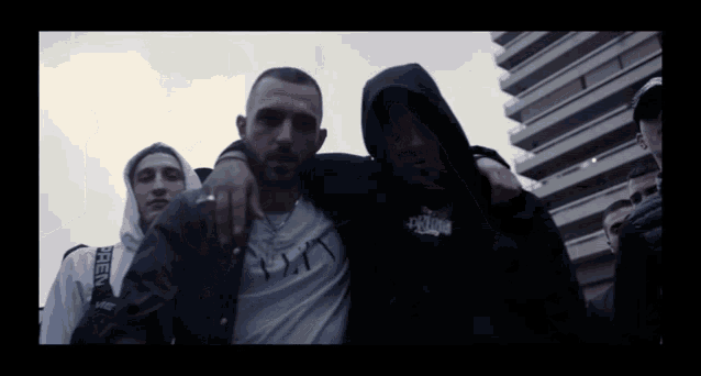 a man in a black hoodie has the word supreme on his chest