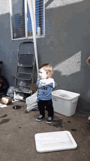 a little boy wearing a shirt that says i am a pirate