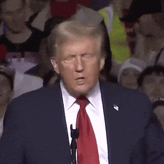 a man in a suit and tie is making a funny face