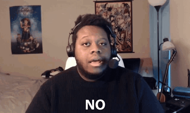 a man wearing headphones says no in front of a kingdom hearts poster