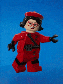 a lego figure with glasses and a red hat is surrounded by sparkles