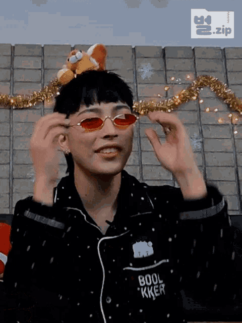 a person wearing red sunglasses and a shirt that says ' boob ' on it