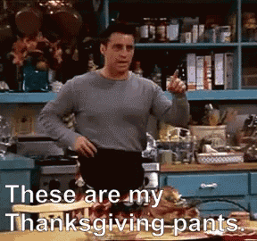 a man standing in a kitchen with the words these are my thanksgiving pants written below him