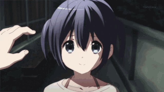 a person touching a girl 's head with tokyo mx written on the bottom