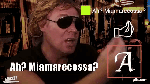 a man wearing sunglasses and a black shirt says " ah ? miamarecossa "