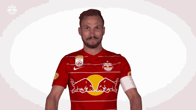 a man in a red shirt with a bull on it