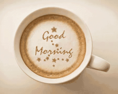 a cup of coffee with the words " good morning " written on the foam