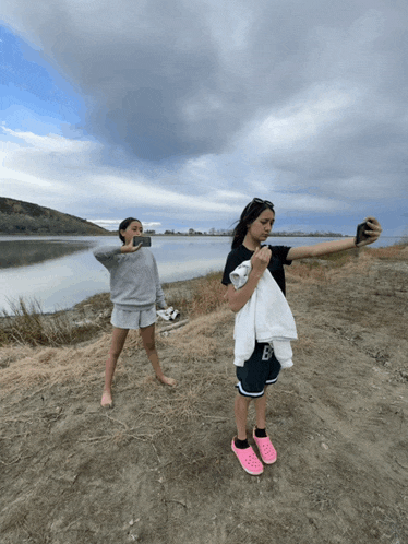 a girl taking a selfie with a towel around her waist that says ea on it