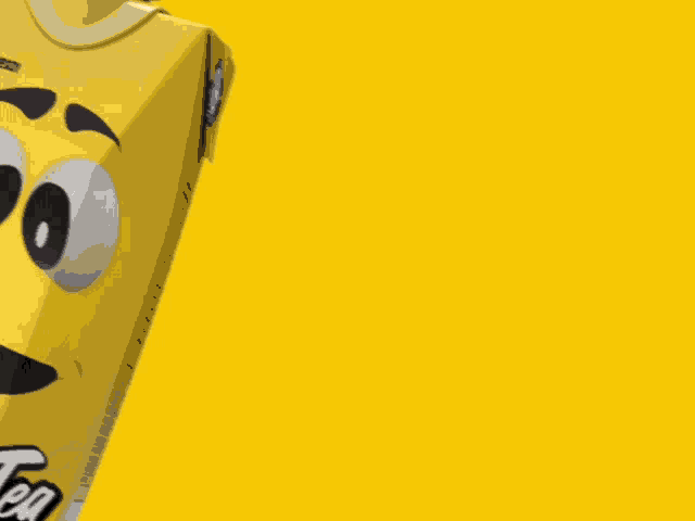 a yellow smiley face with big eyes and a tooth