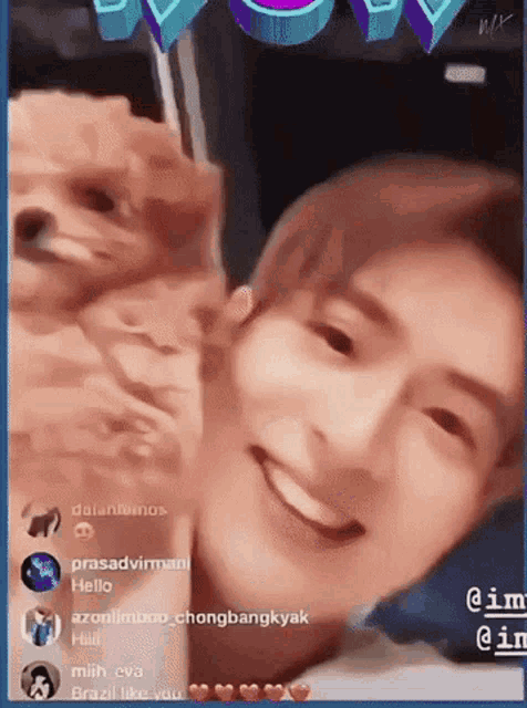 a man is smiling while holding a dog in front of him