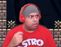 a man wearing headphones and a red shirt with stro on it