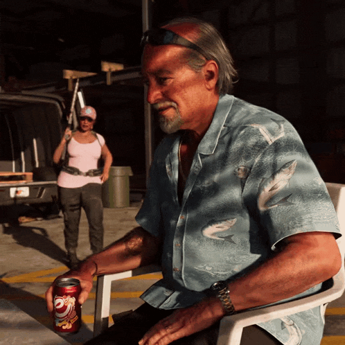a man in a blue shirt is sitting in a chair holding a can of dr pepper