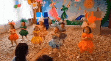 a group of little girls are dancing together in a room