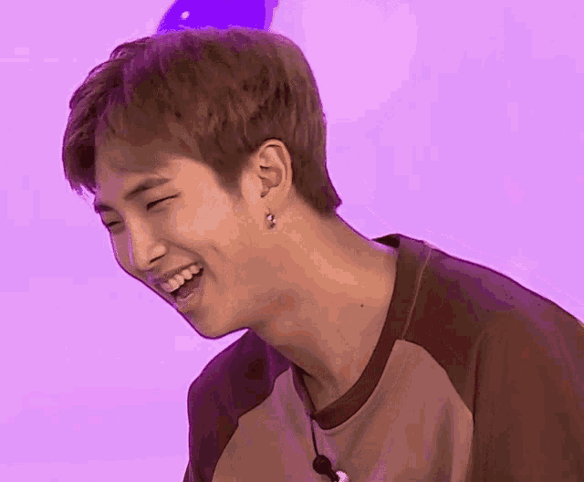 a close up of a person 's face with purple background