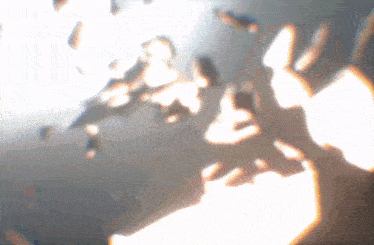 a blurry image of a person 's shadow on a wall with a light shining through it