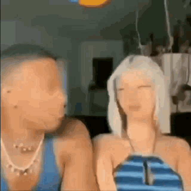 a man and a woman are sitting next to each other .