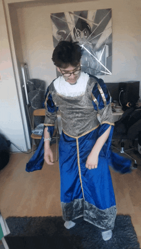 a man in a blue and gold costume is dancing in front of a painting
